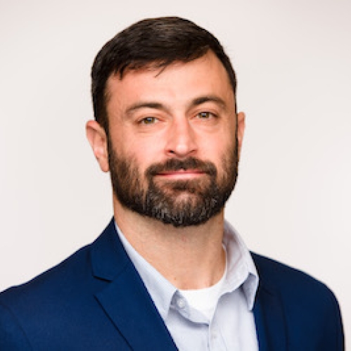 a man with a beard smiling